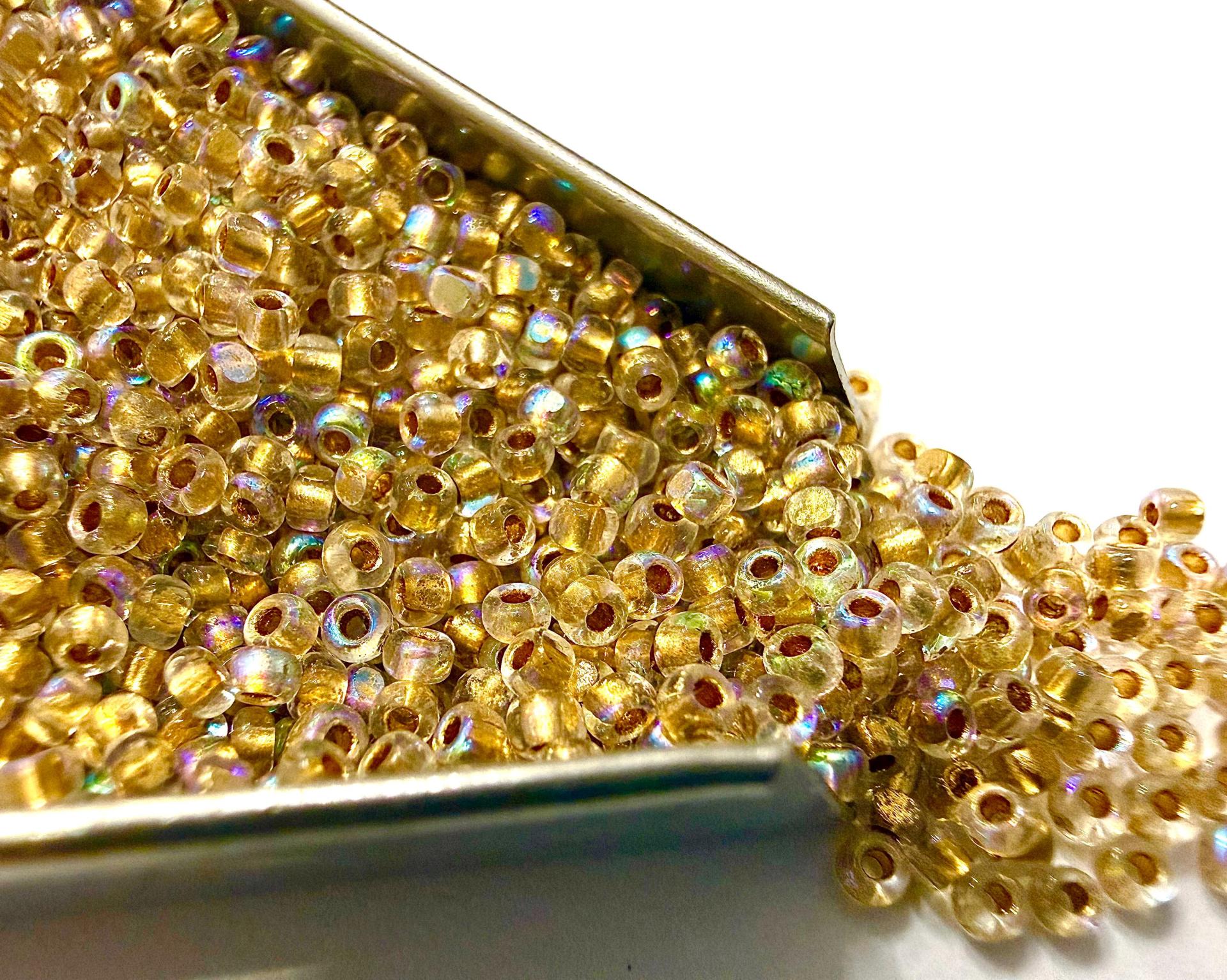 11/0 Charlotte Cut Beads: Patina Dull Gold Lined Aurore Boreale